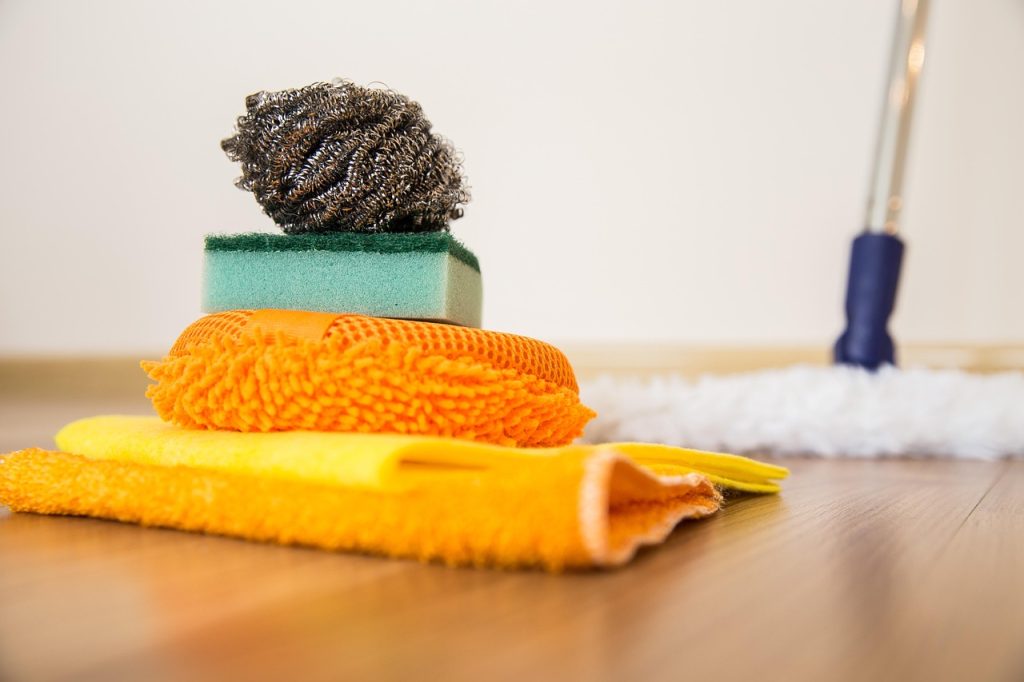 cleaning refrigerator interior with damp cloth