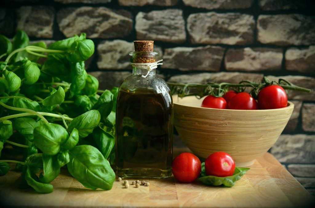 eucalyptus oil bottle with green leaves on wooden desk