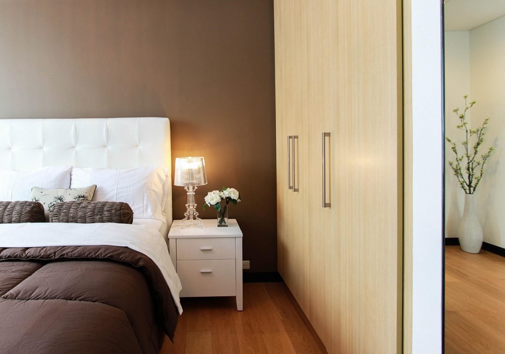 small electric fan on nightstand in a quiet bedroom at night