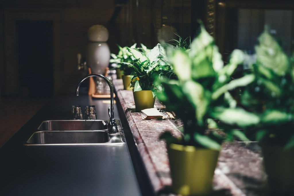 baking soda and hot water poured into kitchen sink drain