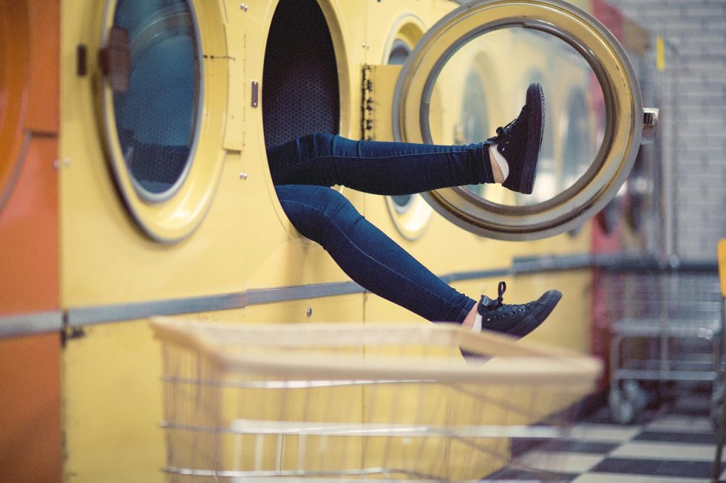 large drum washing machine at laundromat with capacity label