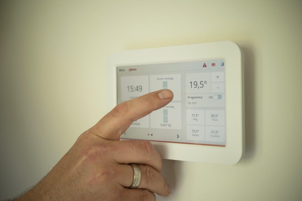 smart thermostat set to away mode on wall