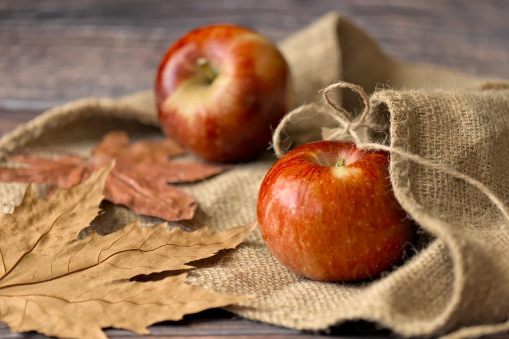apple separated from vegetables in refrigerator with dividers