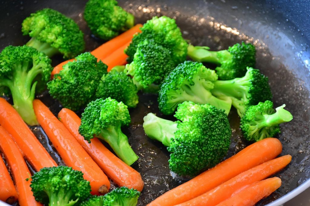 fresh vegetables sorted in refrigerator drawer with paper towels