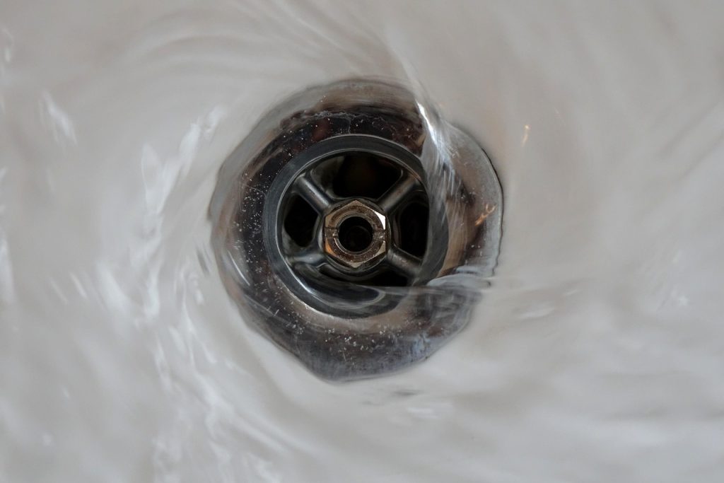 close-up of drain trap U-shape pipe under bathroom