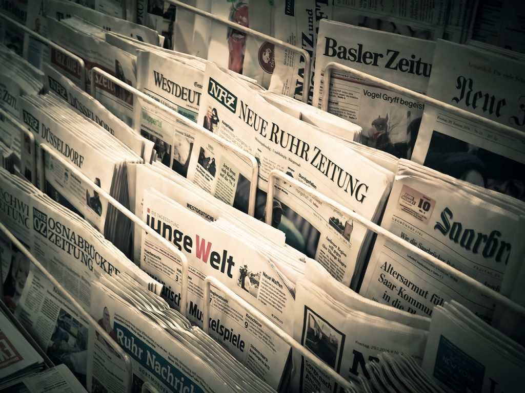 newspaper wiping glass surface