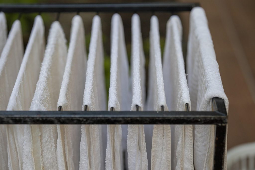 pressing dry towels onto wet comforter to absorb moisture