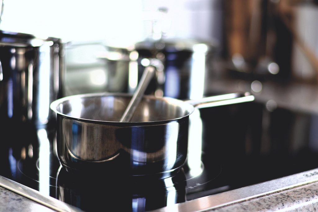 aluminum pot soaking in rice water on kitchen stove