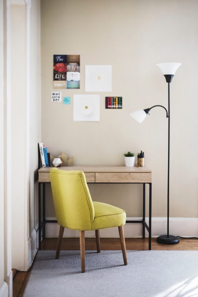 electric fan blowing toward corner of room with furniture