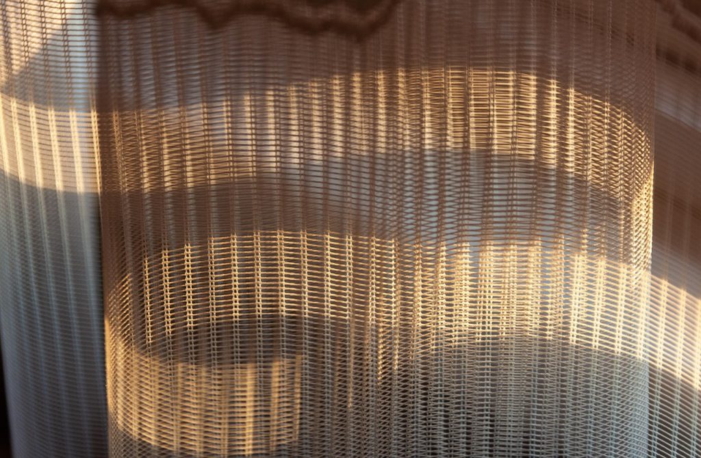 window screen mesh close inspection sunlight gap