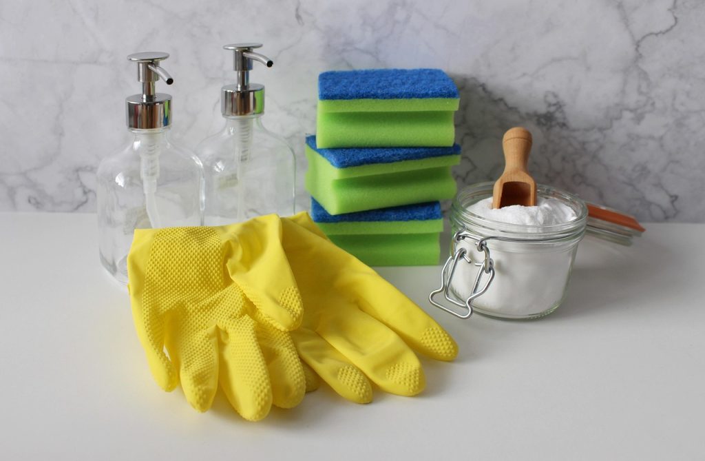 baking soda and dish soap mixed on a sponge next to oily pan