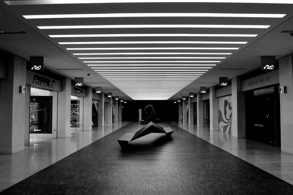 open umbrella drying indoors in a well-ventilated hallway with natural light