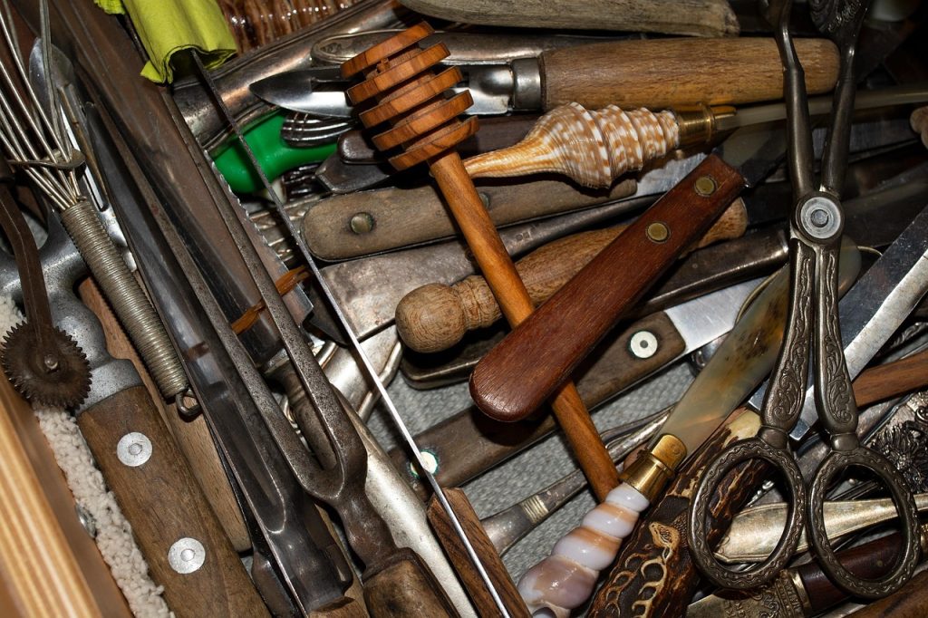 messy kitchen drawer with tangled cooking utensils