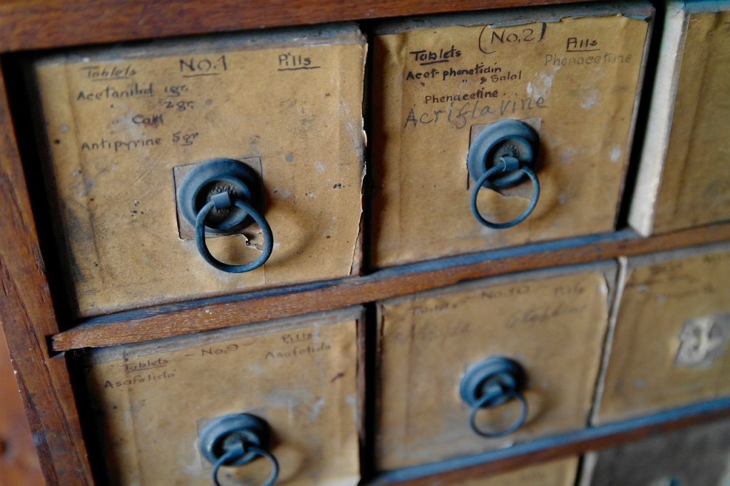 child organizing desk drawer independently with labeled compartments