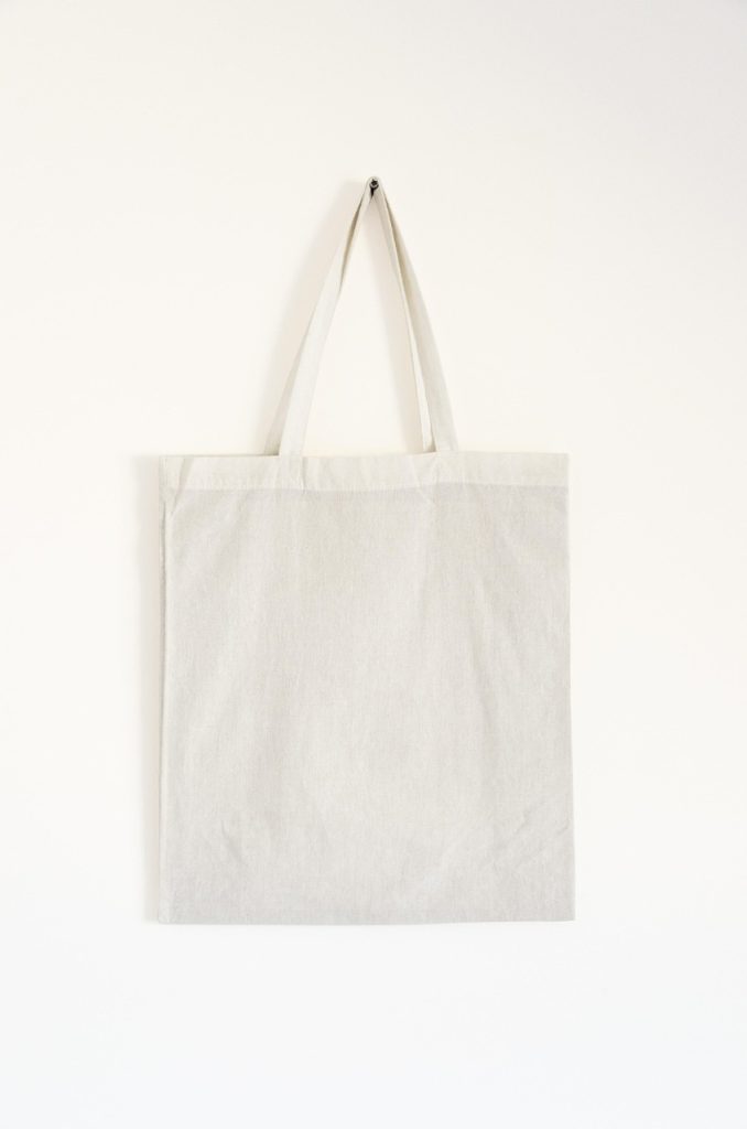 eco bag and reusable tote hanging on door hook