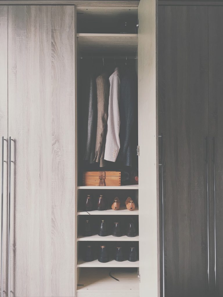minimalist wardrobe with only 30 essential clothing items neatly arranged