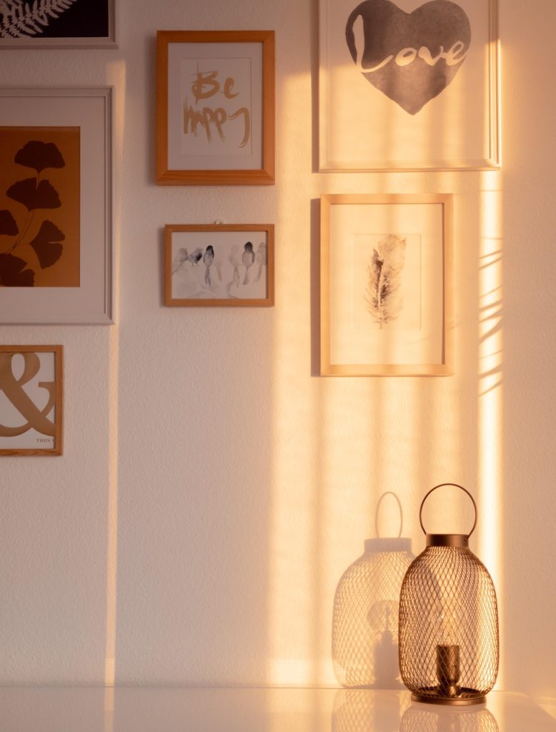 person photographing old item before disposal, warm home lighting, minimalist lifestyle