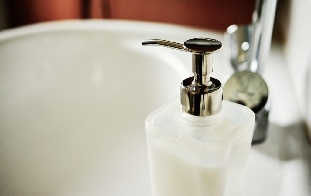 wall-mounted plastic bag dispenser in clean kitchen