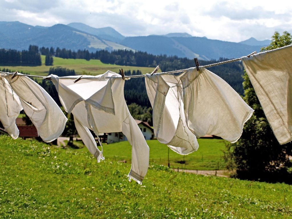 dry cleaning plastic bag hanging on clothes rack with suit inside