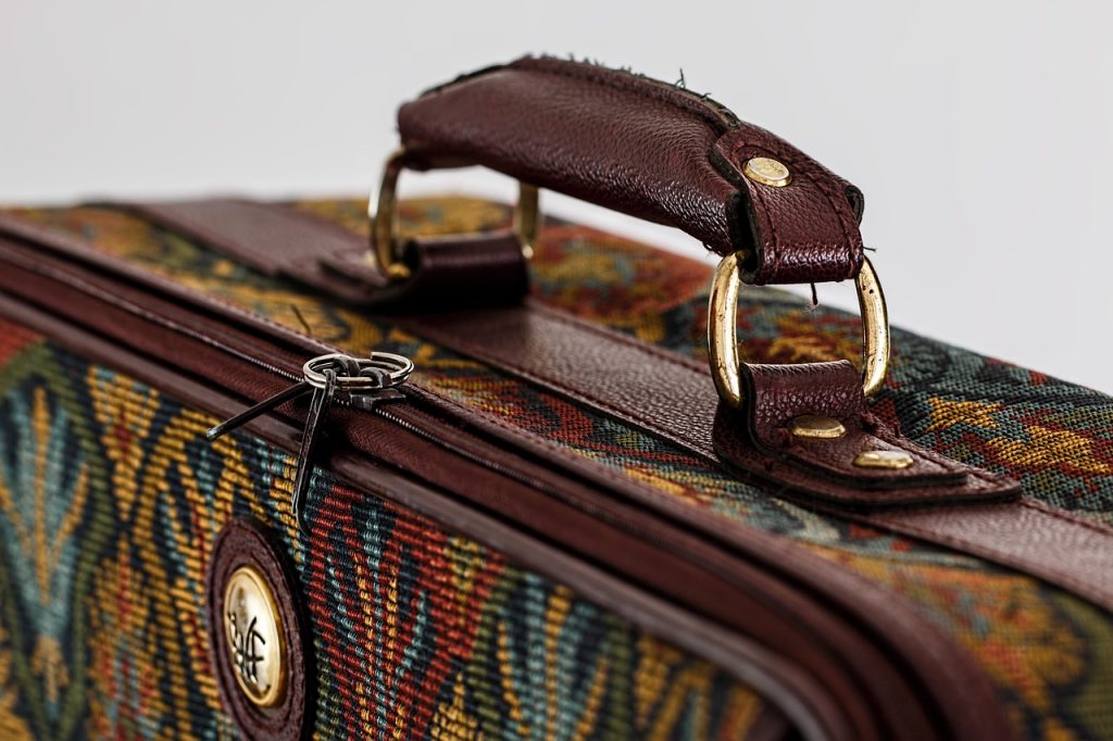 suitcase with clothes wrapped in thin plastic bags neatly packed