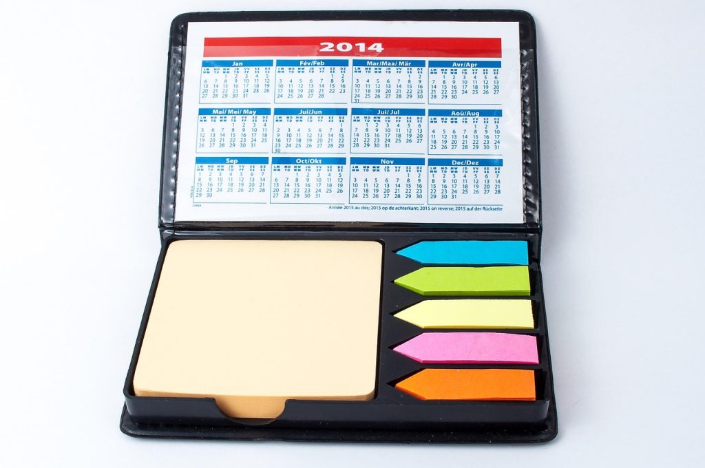 children's artwork portfolio binder with sticky notes and dates