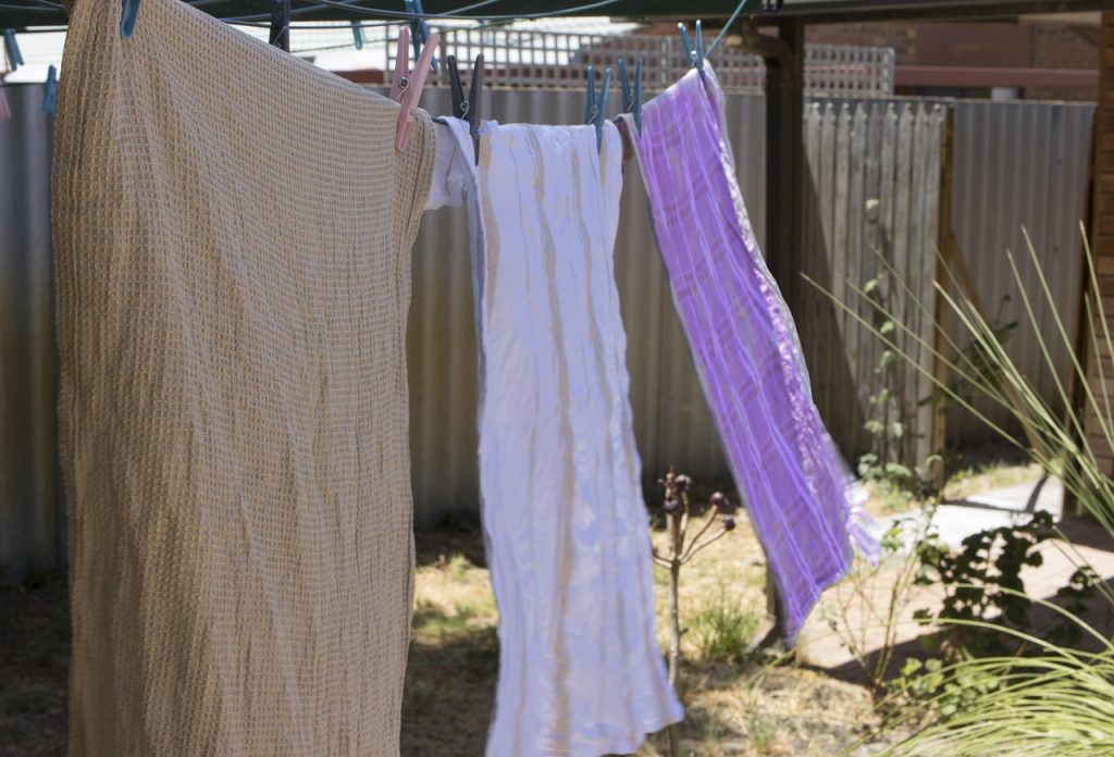 drying kitchen knife with cotton cloth after washing